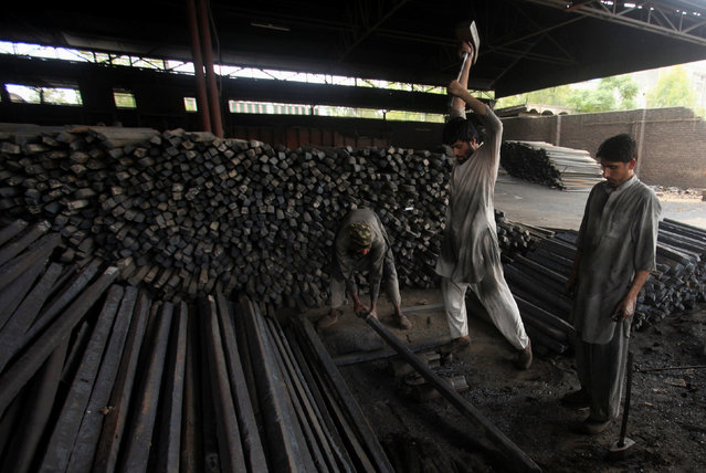 Workers work in a steel plant in the suburbs of Peshawar, Pakistan July 30, 2016. (Photo by Fayaz Aziz/Reuters)