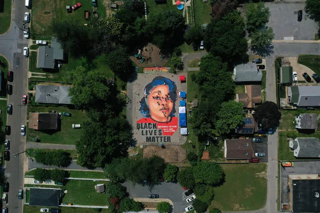 In an aerial view from a drone, a large-scale ground mural depicting Breonna Taylor with the text 'Black Lives Matter' is seen being painted at Chambers Park on July 5, 2020 in Annapolis, Maryland. The mural was organized by Future History Now in partnership with Banneker-Douglass Museum and The Maryland Commission on African American History and Culture. The painting honors Breonna Taylor, who was shot and killed by members of the Louisville Metro Police Department in March 2020. (Photo by Patrick Smith/Getty Images)