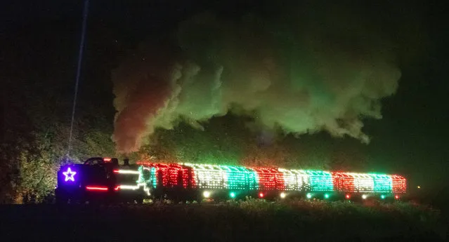 A brightly coloured locomotive and train is the highlight of the “Steam Illuminations” event run by the Mid Hants Railway, travelling through the Hampshire countryside between Alresford and Alton on November 15, 2022. (Photo by Will Dax/Solent News)
