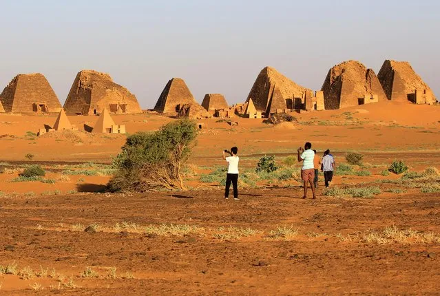 Tourists take pictures of the Royal Cemeteries of Meroe Pyramids in Begrawiya at River Nile State, Sudan on November 10, 2019. Sudan has more – though smaller – pyramids than Egypt, but attracted only about 700,000 tourists in 2018 compared to some 10 million in its northern neighbor. Like the Egyptians, the Nubian Kush dynasty that ruled in the area some 2,500 years ago buried members of the royal family in pyramid tombs. Near Meroe's pyramids lie an array of temples with ancient drawings of animals and the ancient city of Naga, and there are more pyramids further north at Jebel Barka. (Photo by Mohamed Nureldin Abdallah/Reuters)