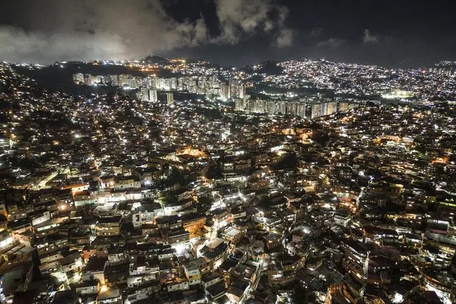 Homes cover a hill in the Petare neighborhood of Caracas, Venezuela, Tuesday, November 15, 2022. The world's population is projected to hit an estimated 8 billion people on Tuesday, according to a United Nations projection. (Photo by Matias Delacroix/AP Photo)