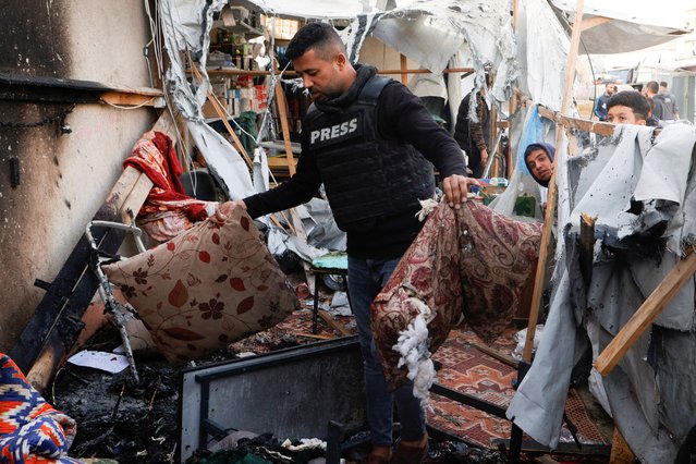 Palestinians inspect the damage to a tent housing journalists after it was hit by an Israeli strike, according to Palestinian Civil Defense, in Khan Younis, southern Gaza Strip, on April 7, 2025. (Photo by Hatem Khaled/Reuters)