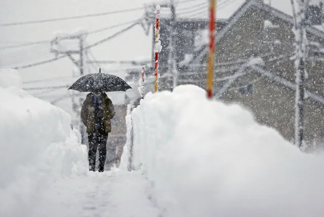A man makes his way in the heavy snow in Uonuma, Niigata Prefecture, Japan in this photo taken by Kyodo on December 20, 2022. (P{hoto by Kyodo News via Reuters)