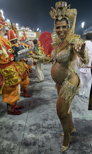 A pregnant dancer from the X-9 Paulistana samba school performs during a carnival parade in Sao Paulo, Brazil, early Saturday, February 9, 2013. (Photo by Andre Penner/AP Photo)