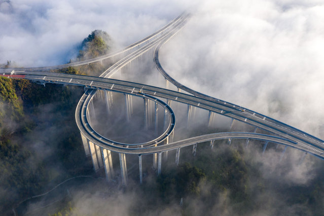 Sea of cloud scenery appears over Shijiazhai Interchange Bridge on March 29, 2024 in Xiangxi Tujia and Miao Autonomous Prefecture, Hunan Province of China. (Photo by VCG/VCG via Getty Images)