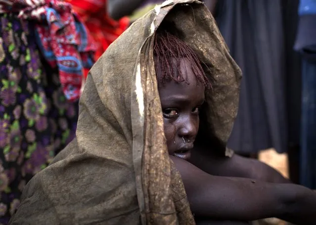 A Pokot girl cries after being circumcised in a village about 80 kilometres from the town of Marigat in Baringo County, October 16, 2014. (Photo by Siegfried Modola/Reuters)