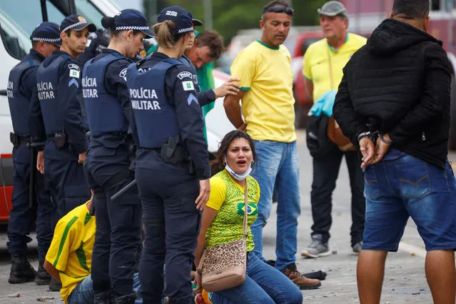 Security forces detain supporters of Brazil's former President Jair Bolsonaro during a demonstration against President Luiz Inacio Lula da Silva, outside Brazil’s National Congress in Brasilia, Brazil on January 8, 2023. (Photo by Adriano Machado/Reuters)