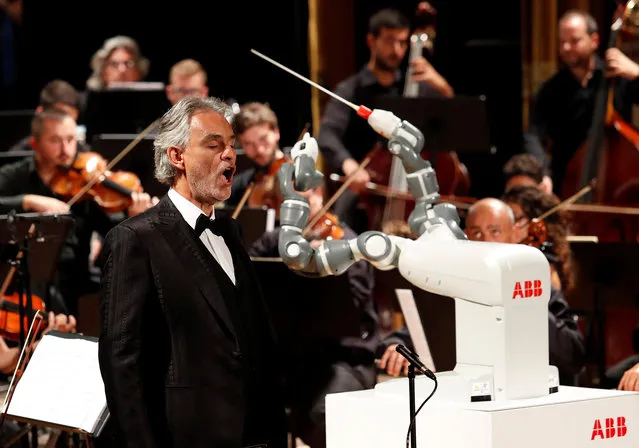 Humanoid robot YuMi conducts the Lucca Philharmonic Orchestra performing a concert alongside Italian tenor Andrea Bocelli at the Verdi Theatre in Pisa, Italy September 12, 2017. (Photo by Remo Casilli/Reuters)
