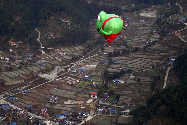 Hot air balloons rise in the sky during the International Hot-Air Balloon festival in Pokhara on December 24, 2024. (Photo by Prakash Mathema/AFP Photo)
