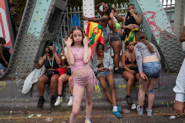 Paint-splattered revellers take a break at the Notting Hill carnival in West London in the last decade of August 2022. (Photo by Andy Hall/The Observer)