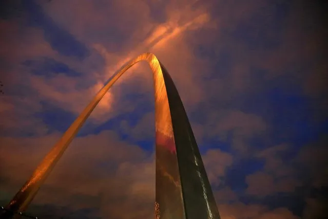 The Gateway Arch is lit with golden-colored lights just before sunrise, Wednesday, October 28, 2015, in St. Louis. The city is celebrating the moment when the final piece of the 630-foot-tall structure was put into place on Oct. 28, 1965. (Photo by David Carson/St. Louis Post-Dispatch via AP Photo)
