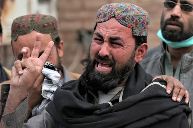 A family member of a police officer, who was killed in Monday's suicide bombing, weeps as he and others take part in a rally denouncing militant attacks and demanding peace in the country, in Peshawar, Pakistan, Friday, February 3, 2023. (Photo by Muhammad Sajjad/AP Photo)