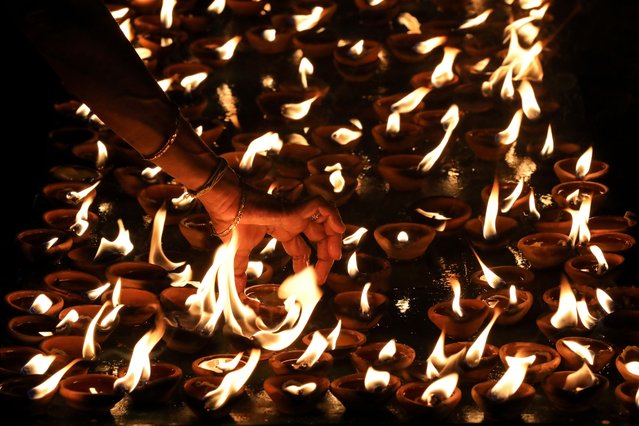 Sri Lankan ethnic Tamil Hindu devotees light oil lamps during the Maha Shivratri festival at a Hindu temple in Colombo, Sri Lanka, 26 February 2025. Hindus around the world celebrate the birthday of Lord Shiva, the Hindu god of creation and destruction, during the Maha Shivratri festival. (Photo by Chamila Karunarathne/EPA)