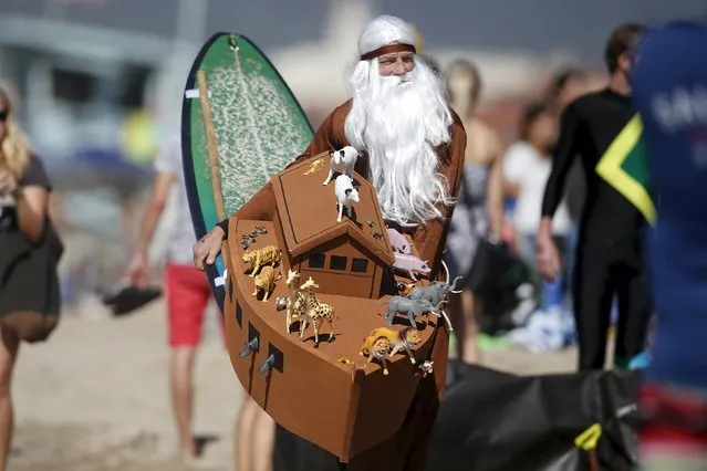 A competitor dressed as Noah walks into the surf with an ark attached to his surfboard during the ZJ Boarding House Haunted Heats Halloween Surf Contest in Santa Monica, California, United States, October 31, 2015. (Photo by Lucy Nicholson/Reuters)