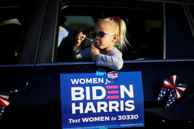 A girl blows soap bubbles during a campaign event of U.S. Democratic vice presidential nominee Senator Kamala Harris in Phoenix, Arizona U.S., October 28, 2020. (Photo by Edgard Garrido/Reuters)
