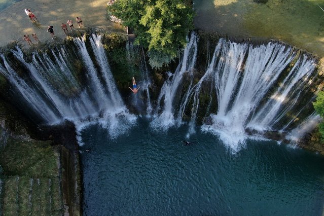A drone view shows competitors taking part in the annual international waterfall jumping competition held in the old town of Jajce, Bosnia and Herzegovina on August 9, 2025. (Photo by Amel Emric/Reuters)