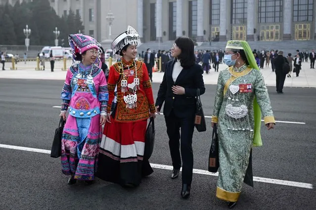 Ethnic minority delegates leave after the second plenary session of the National People's Congress (NPC) at the Great Hall of the People in Beijing on March 7, 2023. (Photo by Wang Zhao/AFP Photo)