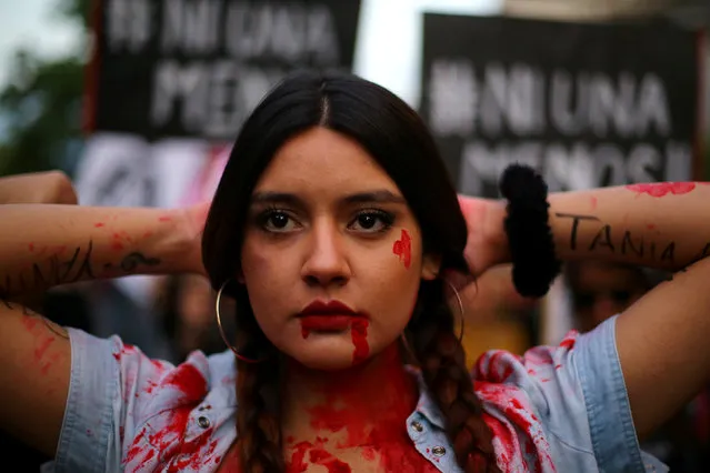 A demonstrator depicting lacerations poses during a peaceful march against gender violence in Santiago, Chile, October 19, 2016. (Photo by Ivan Alvarado/Reuters)