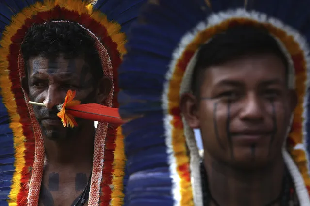 Manoki indigenous men attend the opening ceremony of an annual gathering by Brazil's indigenous peoples at a camp coined “Free Land” in Brasilia, Brazil, Monday, April 23, 2018. Hundreds of indigenous Brazilians are setting up camp in the nation's capital for a week of speeches, protests and celebrations as they lobby the government to protect their rights. (Photo by Eraldo Peres/AP Photo)