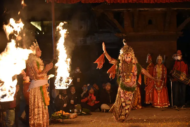 A Nepalese artist dressed as Lord Narsimha performs traditional dance during Kartik Naach festival at Patan Durbar Square, Lalitpur, Nepal on Sunday, November 29, 2020. Kartik Naach is a dance musical play is performed in Kartik Dabali, Patan Durbar Square every year. (Photo by Narayan Maharjan/NurPhoto via Getty Images)