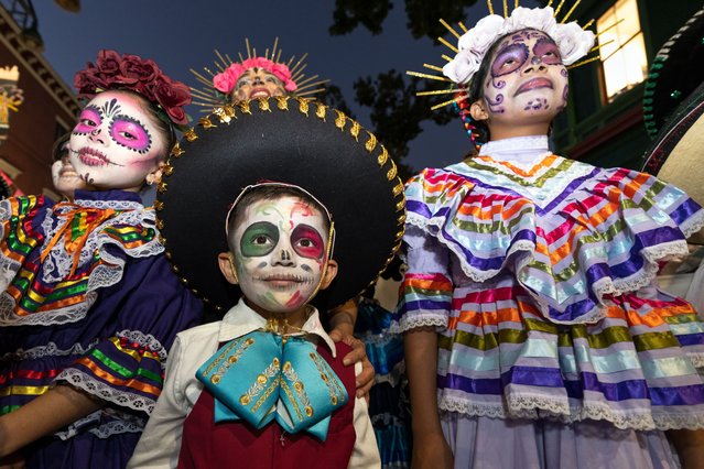 Children wear traditional Mexican costumes and participate in a Day of the Dead celebration in Orlando, Florida on October 16, 2025. The Day of the Dead, or Dia de los Muertos, is a Mexican tradition that honors deceased loved ones with colorful altars, music, and festive gatherings. (Photo by Ronen Tivony/NurPhoto/Rex Features/Shutterstock)