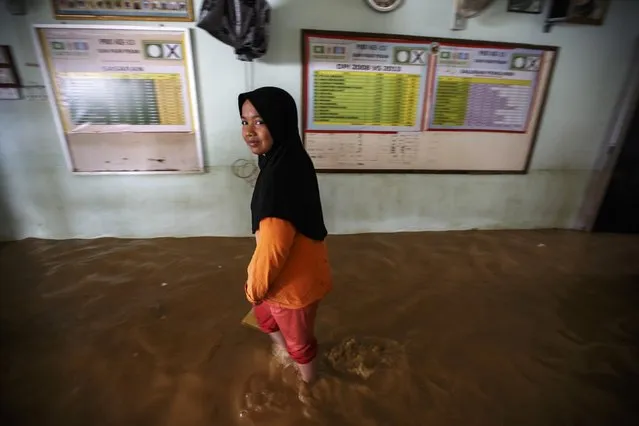 A girl walks inside her flooded house on the outskirt of Kota Bharu in Kelantan December 29, 2014. (Photo by Athit Perawongmetha/Reuters)
