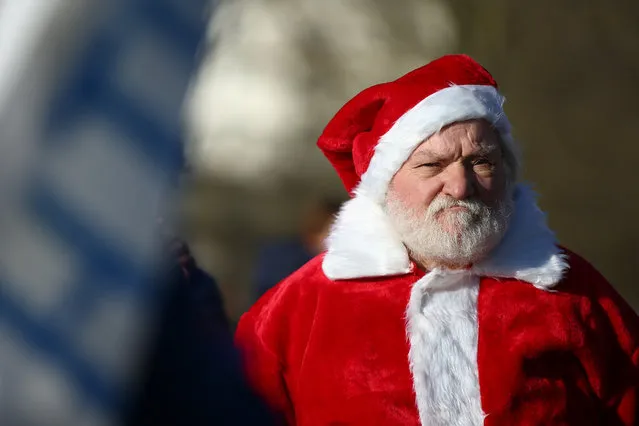 A man dressed as Santa Claus attends a demonstration against the current Covid-19 restrictions in Hyde Park on December 5, 2020 in London, England. London has been in Tier 2 restrictions since the lockdown ended on December 2. (Photo by Hollie Adams/Getty Images)