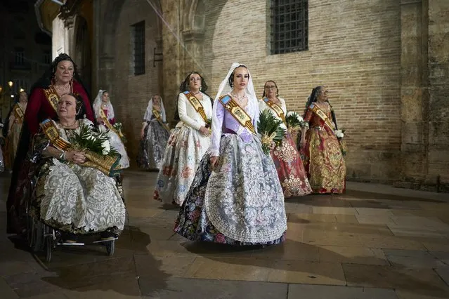 Falleras arrive at the Plaza de la Virgen during the Floral Offering parade on March 17, 2023 in Valencia, Spain. The Fallas festival, which runs from March 15 until March 19, celebrates the arrival of spring with fireworks, fiestas and bonfires made from large Ninots (puppets). (Photo by Manuel Queimadelos Alonso/Getty Images)