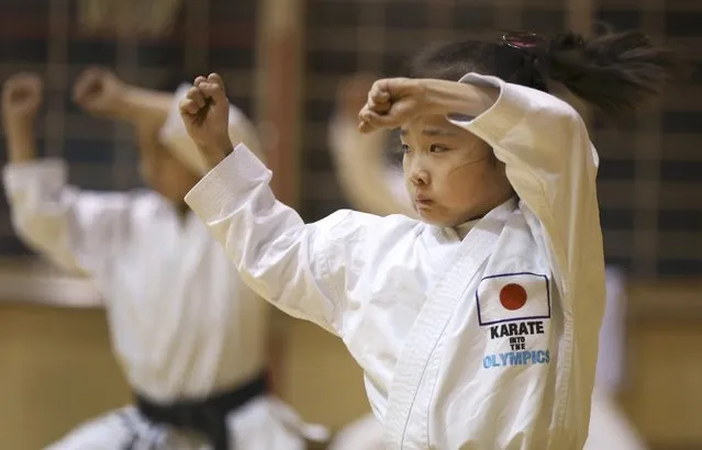 In this November 18, 2015 photo, 9-year-old Mahiro Takano, center, three-time Japan karate champion in her age group practices in Nagaoka, Niigata Prefecture, north of Tokyo. (Photo by Eugene Hoshiko/AP Photo)