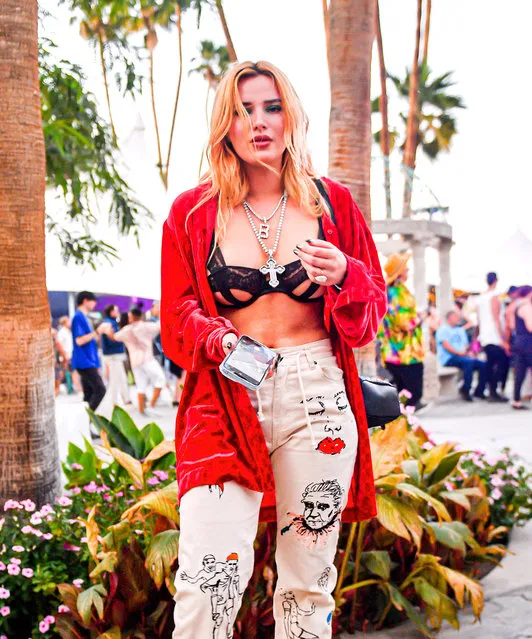Bella Thorne looked sеxy in red while enjoying herself while attending Coachella in Indio, CA on April 16, 2023. (Photo by @CelebCandidly/The Mega Agency)