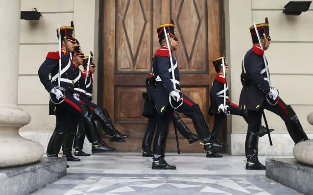 Soldiers from the elite Grenadier Regiment march toward the Casa Rosada presidential palace following a changing of the guard ceremony on November 21, 2015 in Buenos Aires, Argentina. Argentina is facing its first presidential election runoff in the history of the country on Sunday. (Photo by Mario Tama/Getty Images)