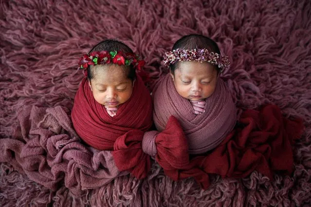 Twins are photographed during a newborn photo shoot by local photographer Fanny Nurdiana in Banda Aceh, Indonesia on March 18, 2022. (Photo by Chaideer Mahyuddin/AFP Photo)