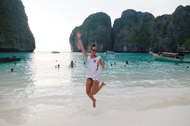 A tourist jumps as she pose for a photo at Maya Bay in Krabi province, Thailand on May 22, 2018. (Photo by Soe Zeya Tun/Reuters)