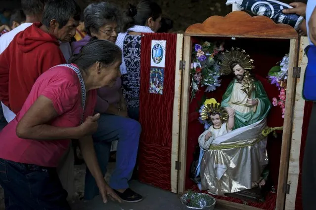 Catholic devotees known as "Cumpas" pray in front of a statue of Saint Joseph during a pilgrimage in the town of Cuishnahuat, El Salvador November 26, 2015. The Catholic people of the El Balsamo mountain range meet in the village of Cuishnahuat in November to celebrate the 'friendship' between their respective patron saints in a ceremony that has been carried out for more than 300 years, according to the government. REUTERS/Jose Cabezas
