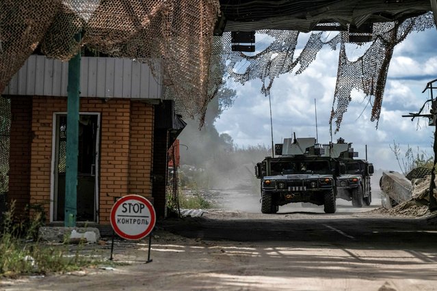 Ukrainian servicemen ride military vehicles from a crossing point at the border with Russia, in Sumy region, Ukraine on August 13, 2024. (Photo by Viacheslav Ratynskyi/Reuters)