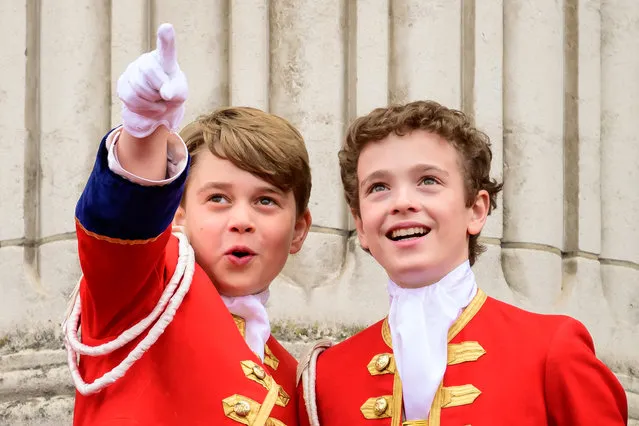 Prince George (L) points while on the balcony of Buckingham Palace during the Coronation of King Charles III and Queen Camilla on May 06, 2023 in London, England. The Coronation of Charles III and his wife, Camilla, as King and Queen of the United Kingdom of Great Britain and Northern Ireland, and the other Commonwealth realms takes place at Westminster Abbey today. Charles acceded to the throne on 8 September 2022, upon the death of his mother, Elizabeth II. (Photo by Leon Neal/Pool via Reuters)