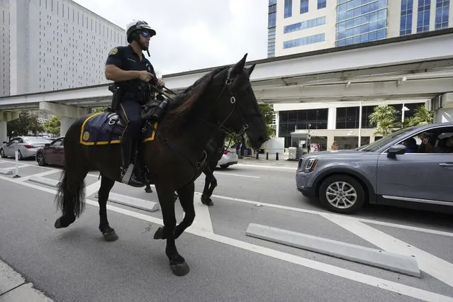 Mounted police ride around the Wilkie D. Ferguson Jr. U.S. Courthouse, Tuesday, June 13, 2023, in Miami. Former President Donald Trump is making a federal court appearance on dozens of felony charges accusing him of illegally hoarding classified documents and thwarting the Justice Department's efforts to get the records back. (Photo by Chris O'Meara/AP Photo)