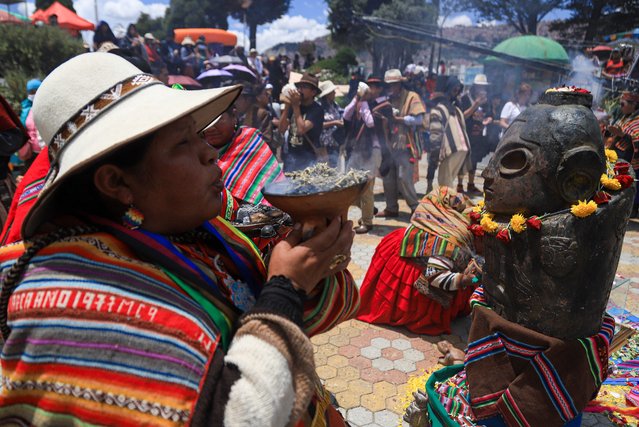 A woman participates in a ritual to welcome the summer solstice, in La Paz, Bolivia, 21 December 2024. Ancestral rituals, music and native dances, as well as offerings to the Andean deities to ask for rain and abundance were part of the festivities held to celebrate the change of the agricultural cycle from the southern summer solstice. (Photo by Gabriel Marquez/EPA/EFE)