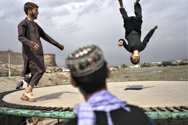 Children jump in a trampoline at a public park in Kabul, Afghanistan, Wednesday, May 31, 2023. (Photo by Rodrigo Abd/AP Photo)