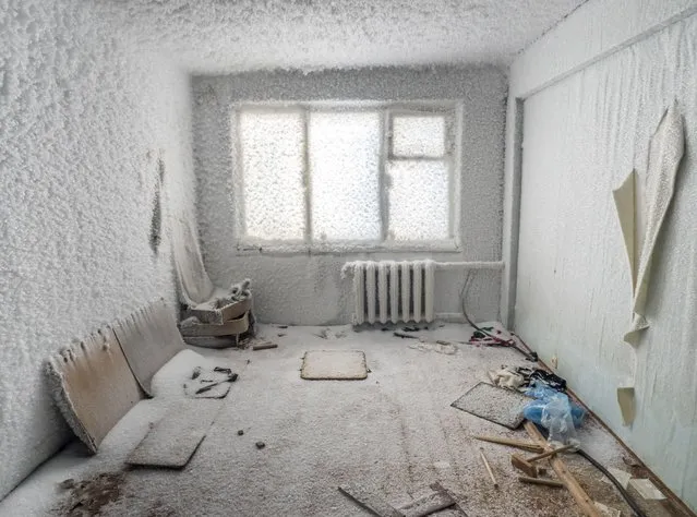 An inside view from snow and ice covered abandoned building in Sementnozavodsky region, 19 kilometers from coal-mining town Vorkuta, Komi Republic, Russia on March 01, 2021. (Photo by Maria Passer/Anadolu Agency via Getty Images)