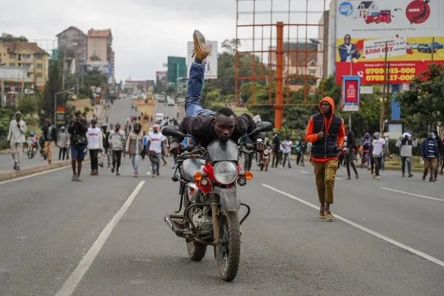 A demonstrator shows off as he rides a motorcycle during protests in the capital Nairobi, Kenya Friday, July 7, 2023. (Phoot by Brian Inganga/AP Photo)