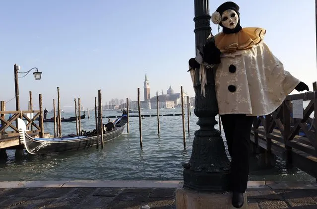 A masked reveller poses at Saint Mark's square during Carnival in Venice, February 8, 2015. (Photo by Stefano Rellandini/Reuters)