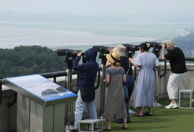 Visitors watch the North Korean side from the Unification Observation Post in Paju, South Korea, Thursday, July 20, 2023. North Korea wasn't responding Thursday to U.S. attempts to discuss the American soldier who bolted across the heavily armed border and whose prospects for a quick release are unclear at a time of high military tensions and inactive communication channels. (Photo by Ahn Young-joon/AP Photo)