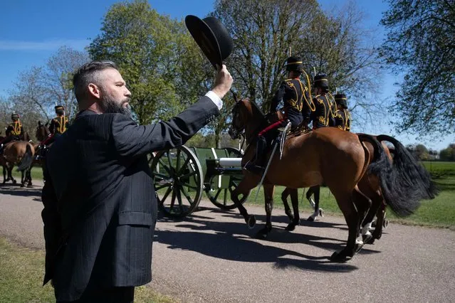 A person salutes the King's Troop Royal Horse Artillery as they make their way down the Long Walk towards Windsor Castle, as the funeral of the Duke of Edinburgh takes place in St George's Chapel, at Windsor Castle, Berkshire on Saturday, April 17, 2021. (Photo by Andrew Matthews/PA Images via Getty Images)