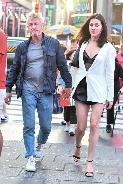 Sean Penn and his new girlfriend Olga Korotyayeva head to Times Square in New York City on July 22, 2023. The 62 year old actor and his 43 year old actress girlfriend kept close holding hands as they strolled the streets with Olga wearing a black top with a short black skirt under a white blazer and black heels. (Photo by The Image Direct)