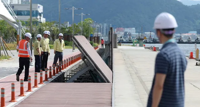 Engineers test wave barriers set up along the coast in Masan, South Korea 08 August 2023, as Typhoon Khanun is predicted to hit the country's southeastern region two days later. (Photo by Yonhap/EPA)