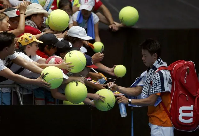 Japan's Kei Nishikori signs autographs after winning his first round match against Germany's Philipp Kohlschreiber at the Australian Open tennis tournament at Melbourne Park, Australia, January 18, 2016. (Photo by Issei Kato/Reuters)