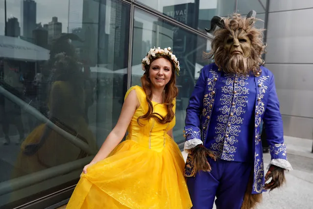 People dressed as characters from Beauty and the Beast attend the 2018 New York Comic Con in Manhattan, New York on October 4, 2018. (Photo by Shannon Stapleton/Reuters)