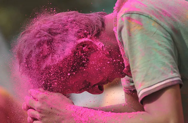 Indian revellers play with coloured powder during Holi celebrations in Hyderabad on March 6, 2015.  Holi, also called the Festival of Colours, is a popular Hindu spring festival observed in India at the end of the winter season on the last full moon day of the lunar month.  AFP PHOTO / Noah SEELAM        (NOAH SEELAM/AFP/Getty Images)