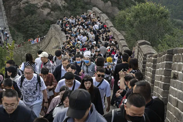 People crowd as they visit a section of the Great Wall during the National Golden Week holiday  on October 2, 2023 in Beijing, China. The holiday begins with China's National Day on October 1st. (Photo by Kevin Frayer/Getty Images)
